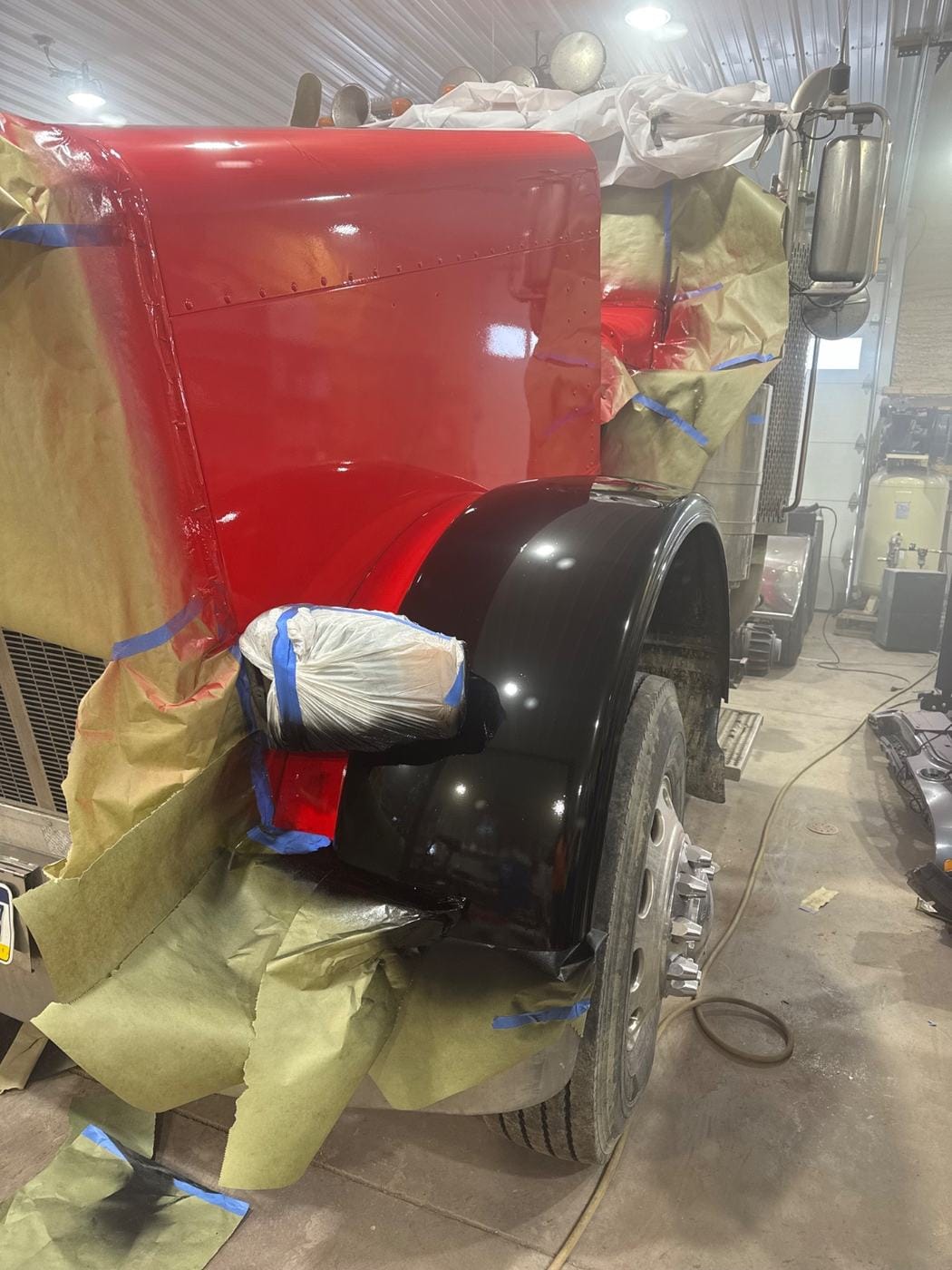 A truck front end masked off for paint.