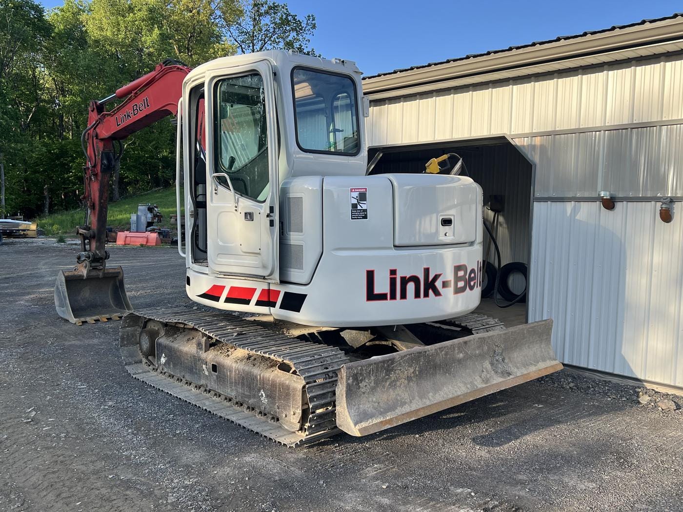 An excavator parked by the shop.