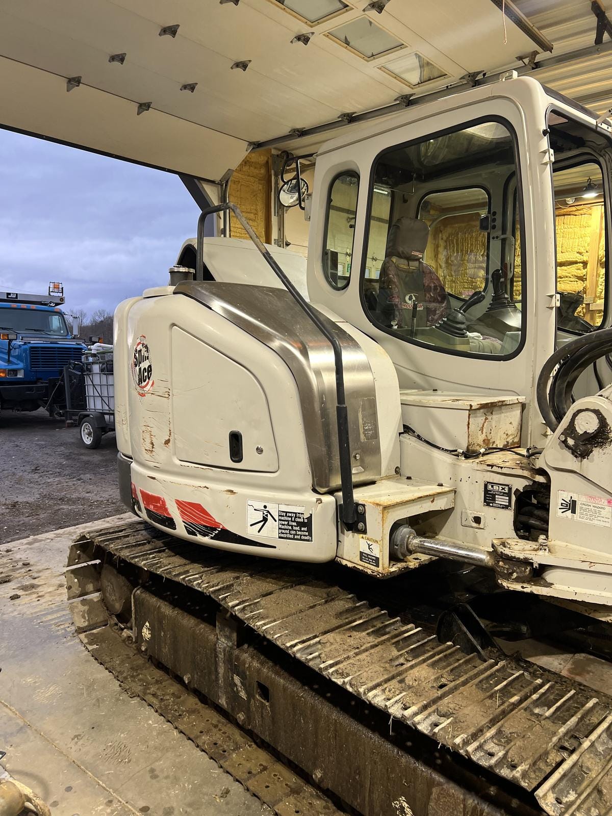 An excavator pulled into the shop.